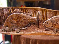 Three feeding carp plaque: relief-carved